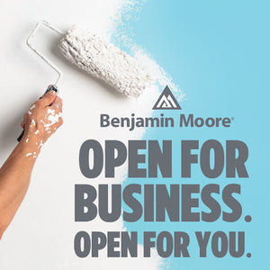 White paint roller going over sky blue paint and grey text that says "Benajmin Moore: Open for business. Open for you"